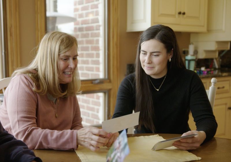 Two people sit together while talking.